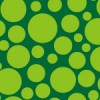 様々なサイズの緑の円が散らばるパターン